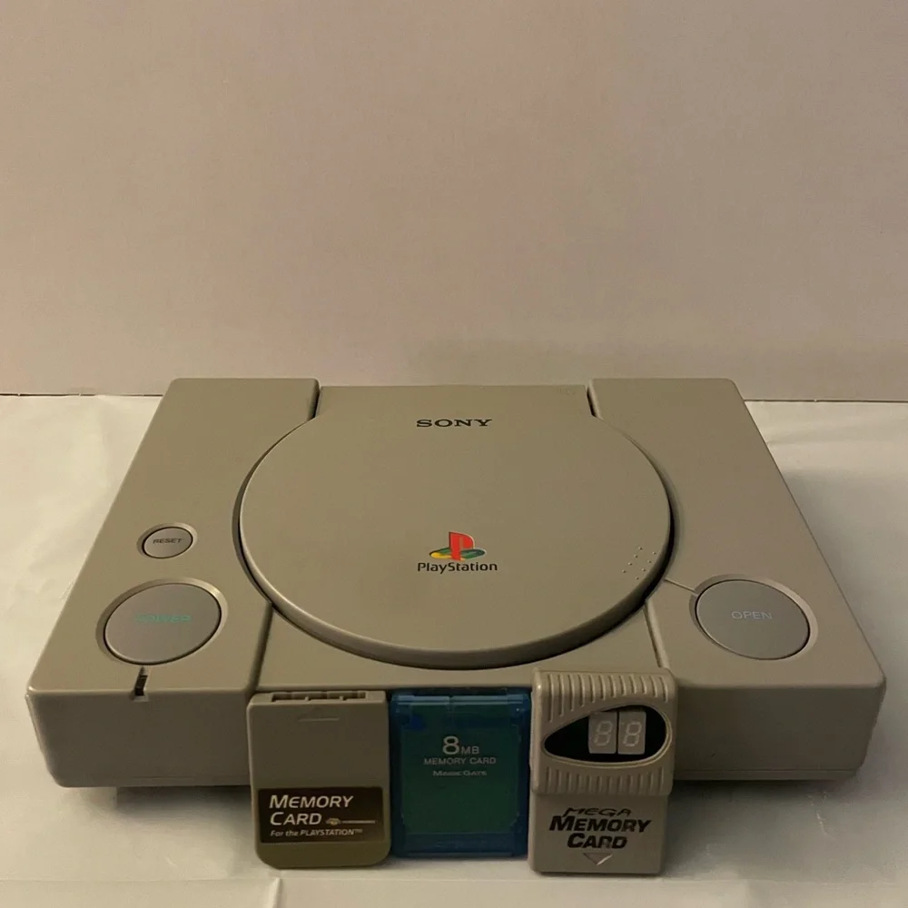 PLAYSTATION 1 WITH TWO CONTROLLERS AND 3 MEMORY STICKS NO CORDS